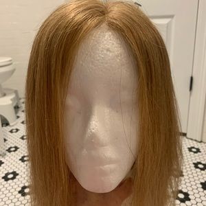 Human hair strawberry blonde lace front wig.